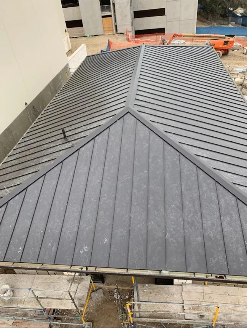 Commercial metal roof construction with crane equipment in Brunswick